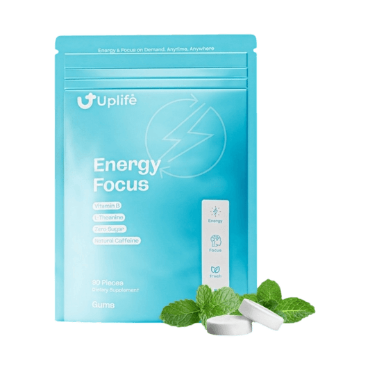 A light blue stand-up pouch labeled 'Uplife Energy Focus' with mint leaves and two white tablets in front, shown on a solid black background.